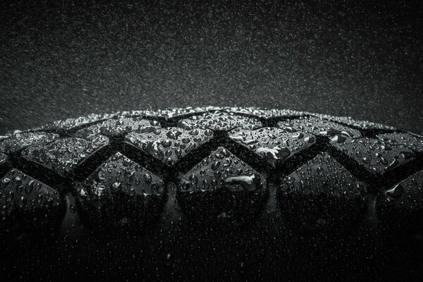 Wet car tire on black background