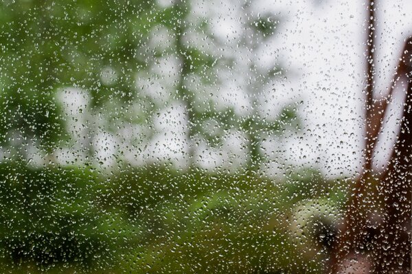 Raindrops on the glass with a blurred background