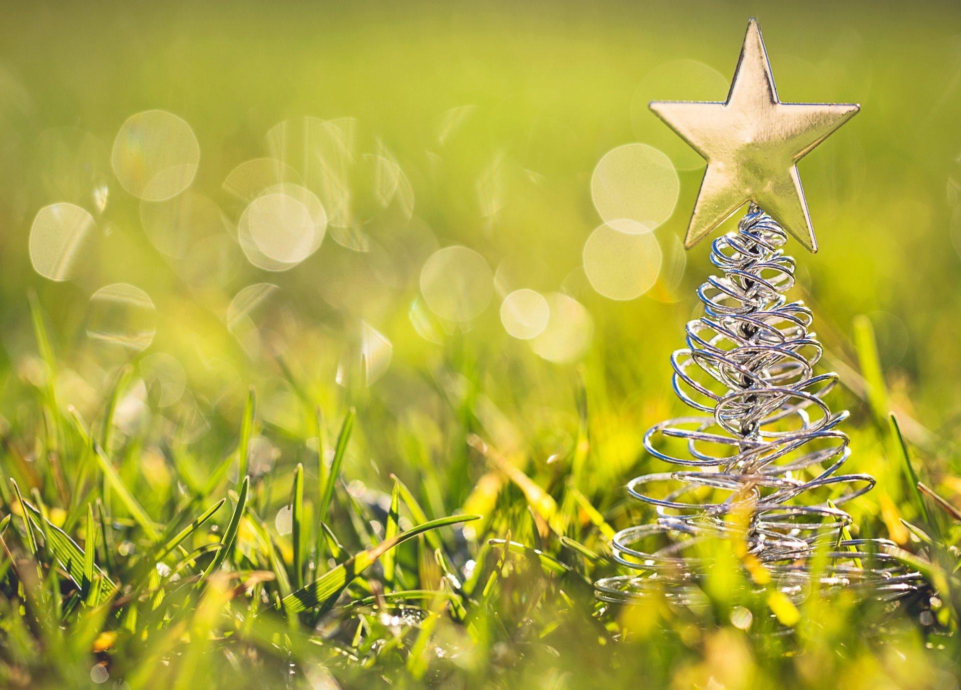 christmas tree toys figurine star grass green bokeh close up