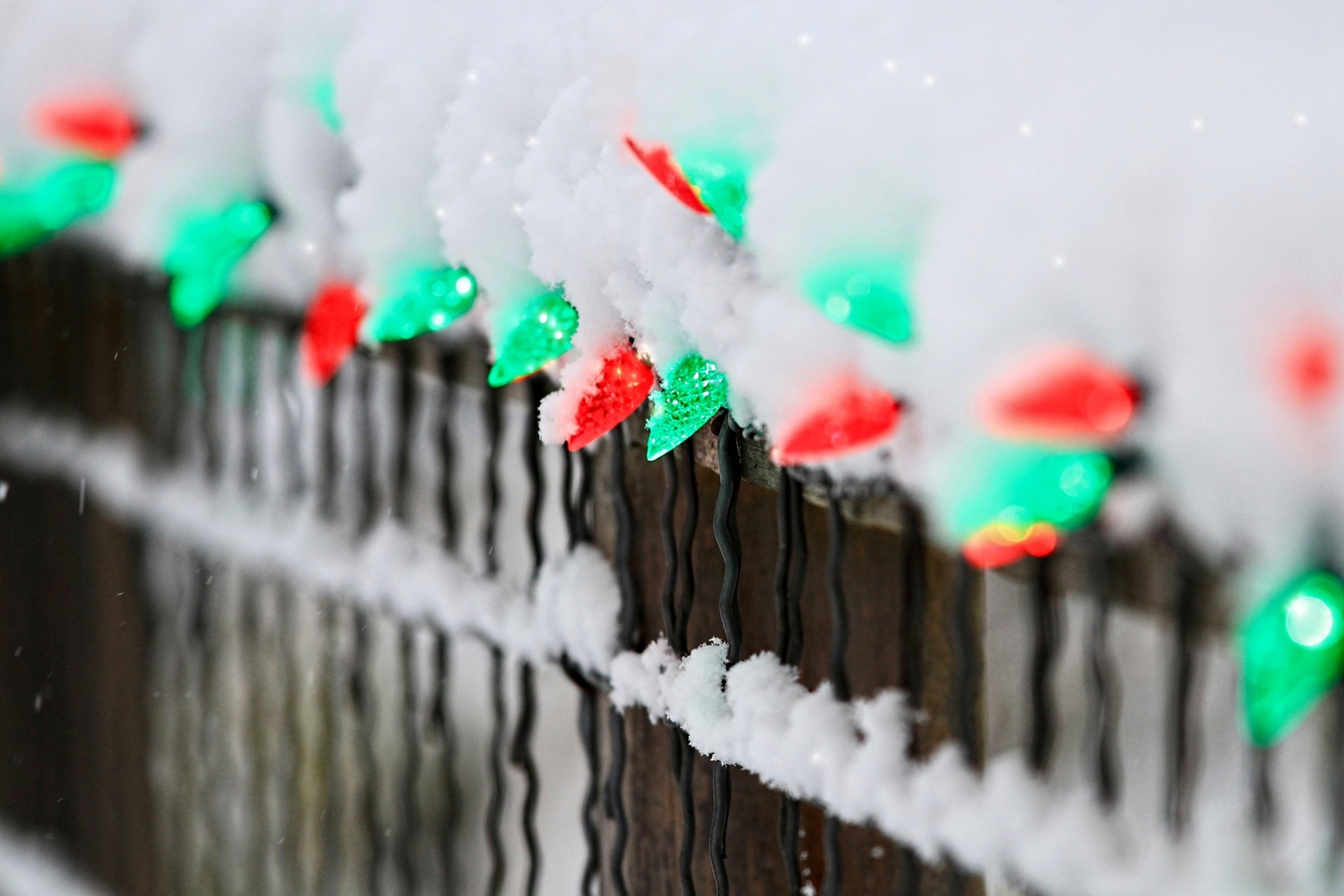 garland lights red green fence fence snow winter holiday