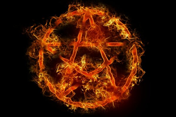 The pentagram symbol is on fire on a black background