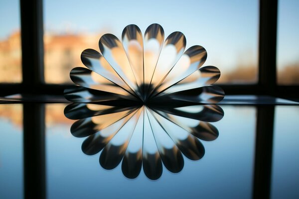 Reflection of a silver-transparent fan