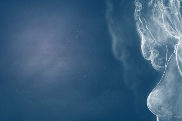 The face of a girl made of smoke on a blue background