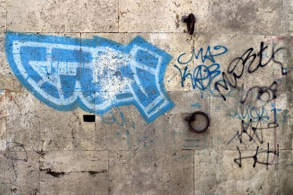 Blue graffiti on a concrete wall