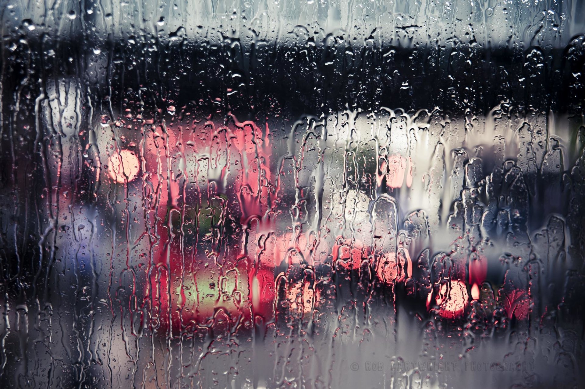 rain downpour glass water streams city street bokeh