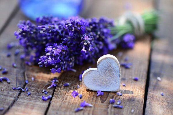 Lavender becket on a wooden table with a heart