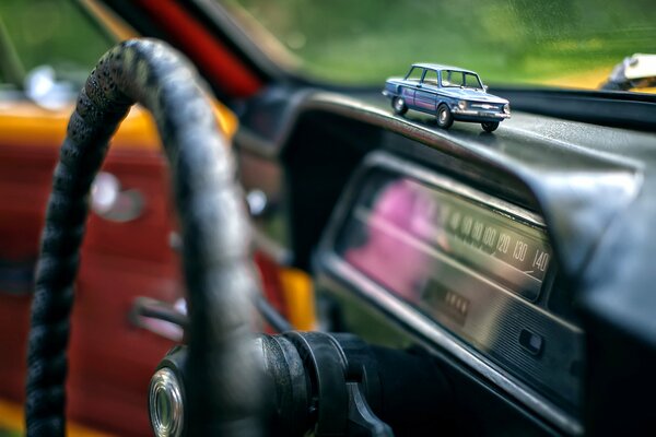 Car panel with toy car Zaporozhets in macro photography