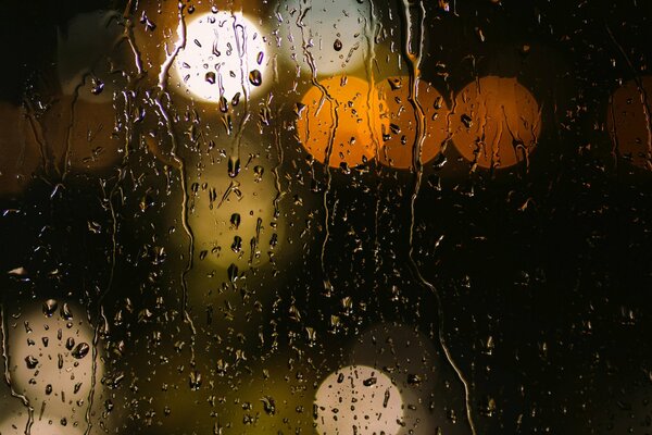 Raindrops on yellow glass