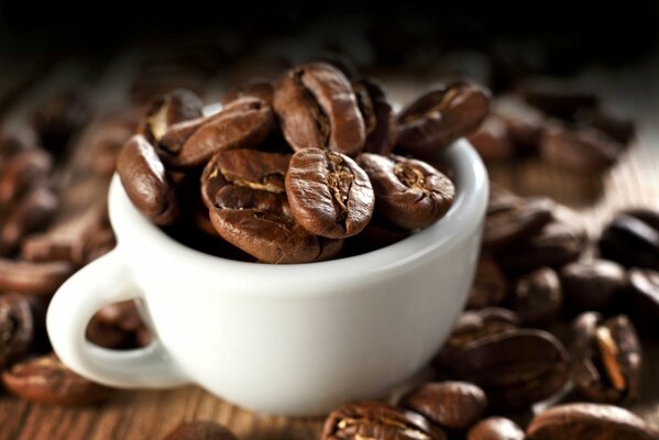 Chicchi di caffè in una tazza bianca