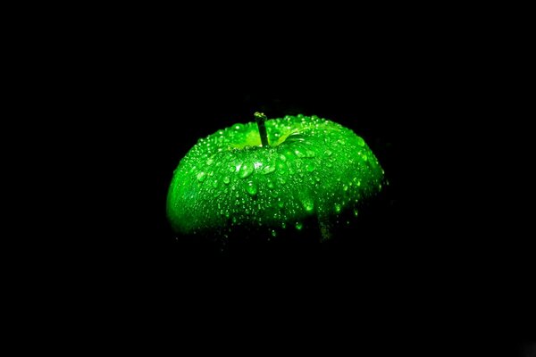 Droplets on an apple on a black background