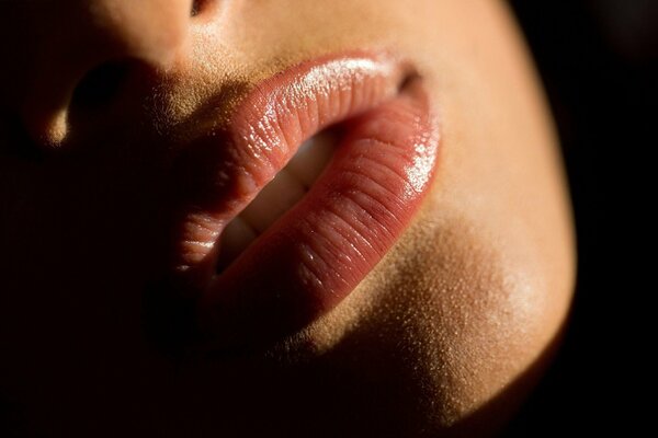 Juicy plump lips of a girl close-up