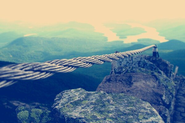 A tightrope to a lighthouse in the mountains