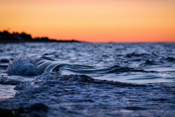 Evening waves on the background of sunset