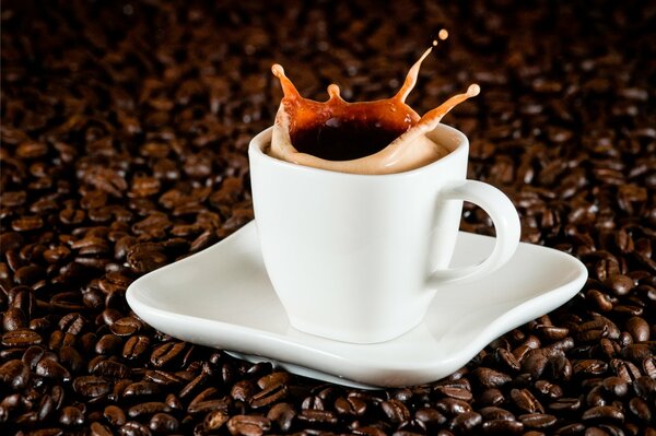 A cup of coffee on the background of coffee beans