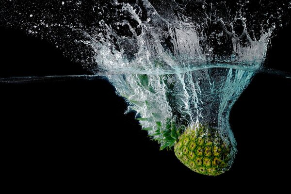 Splashes from a pineapple that fell into the water