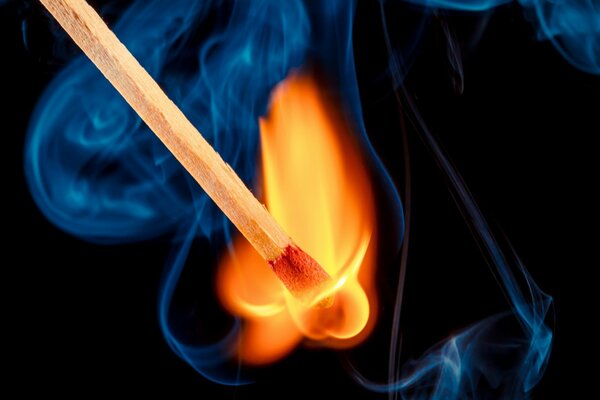 Fire from a lit match and smoke