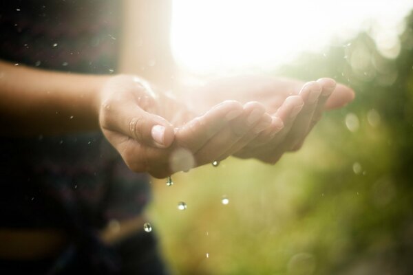 Gocce d acqua che cadono nelle mani