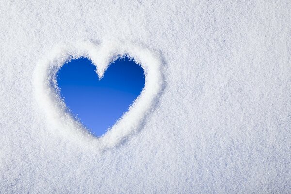 A heart on a glass made of snow. Winter
