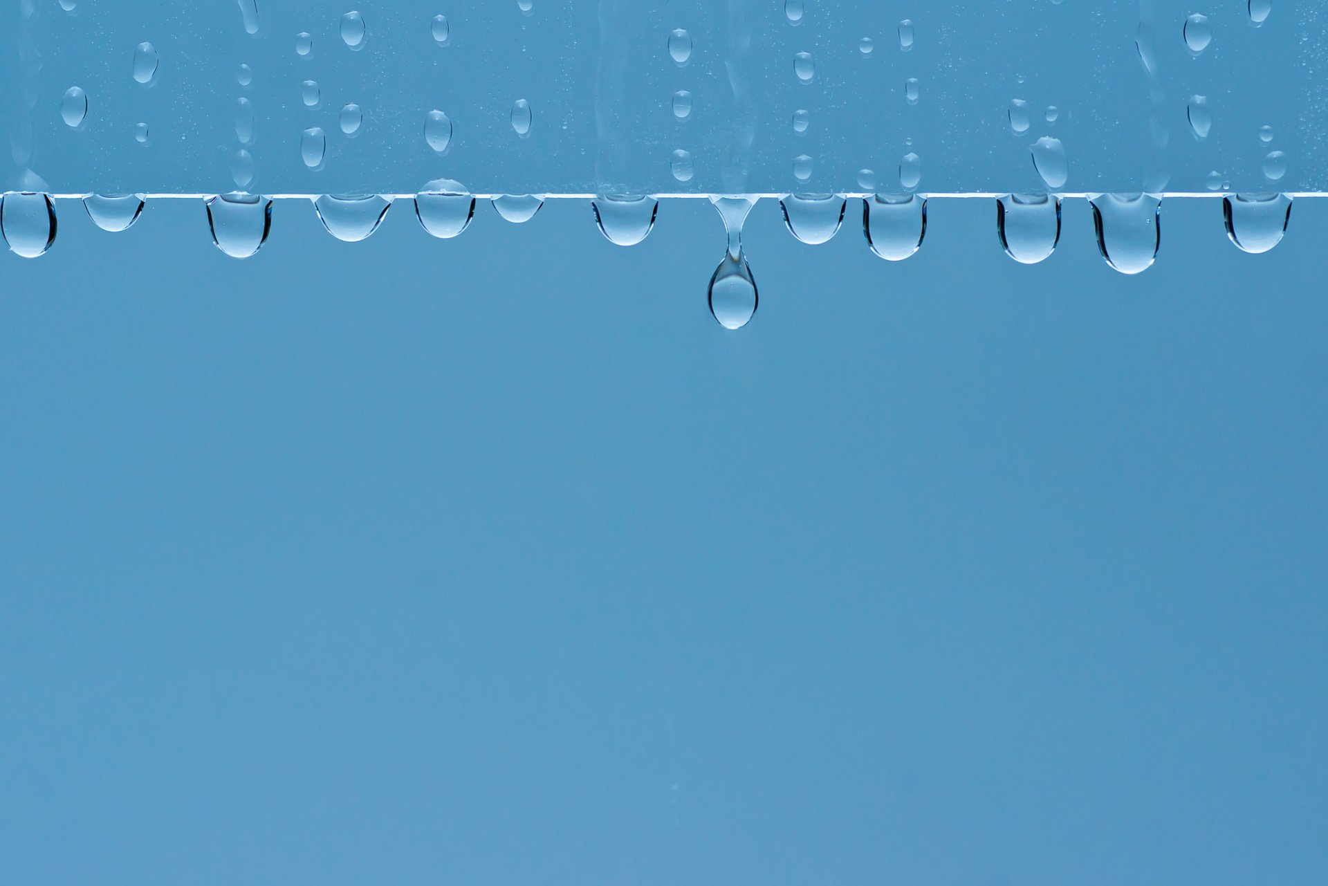 close up drops minimalism blue background