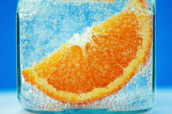 A slice of orange in a glass of water
