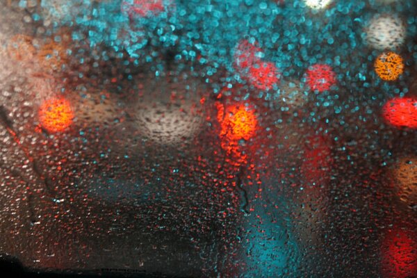 The road in the rain. Drops on the glass