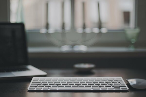 Desktop with keyboard, mouse and laptop