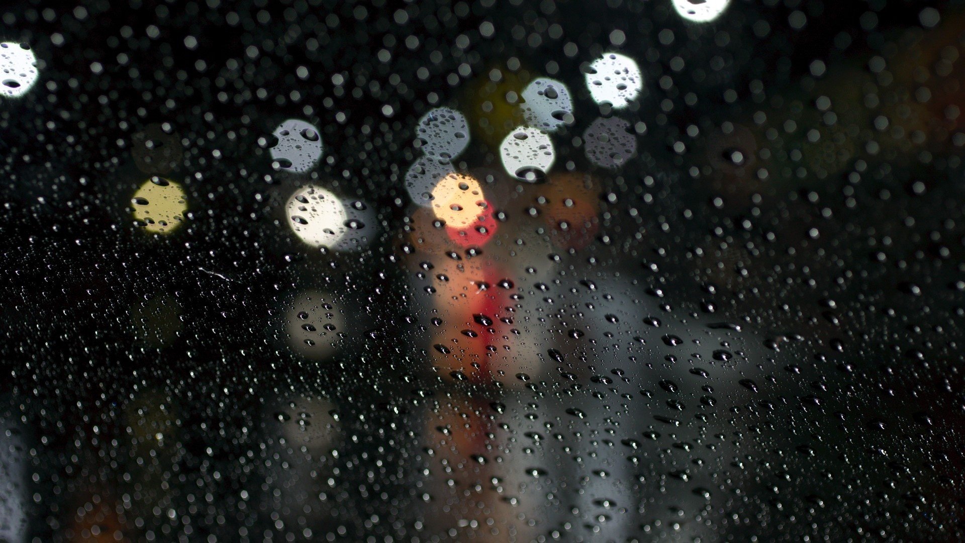 glass rain drops water bokeh close up