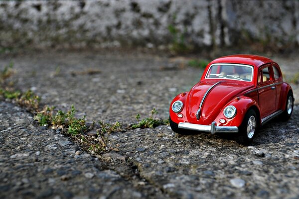 A small red car among the concrete