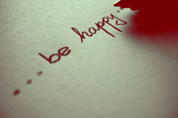 Be happy inscription on paper in English