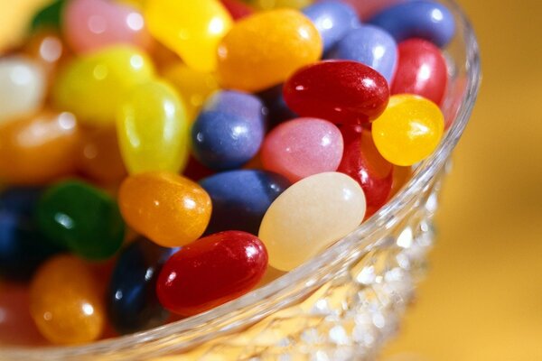 Sweet candy dragees in a transparent vase