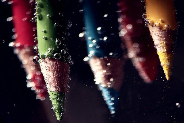 Pencils view underwater with bubbles