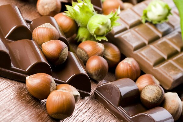 Hazelnuts and dark chocolate bars on the table