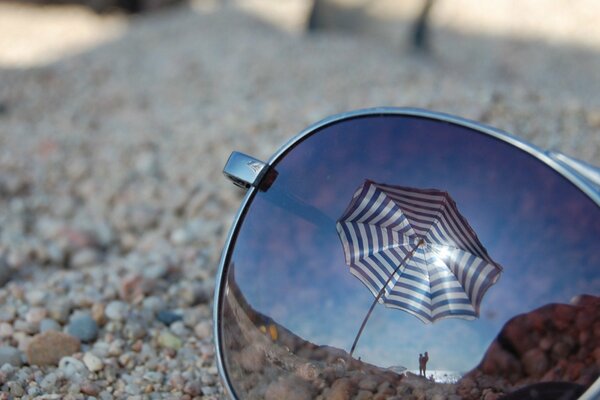 Reflections of glasses on the beach