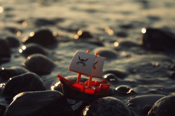 Two pirate ship toys on the rocks