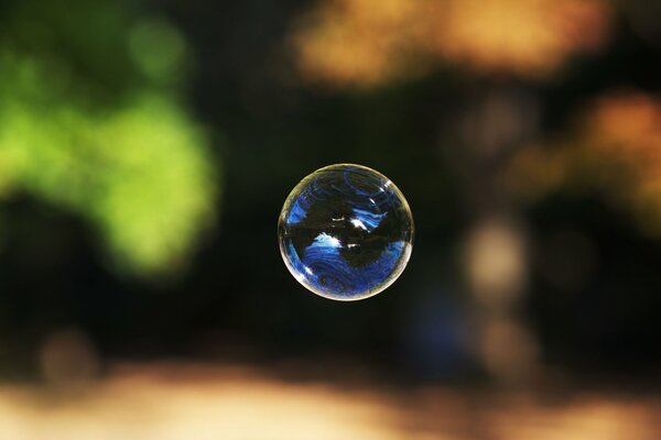 Blue soap bubble in the air