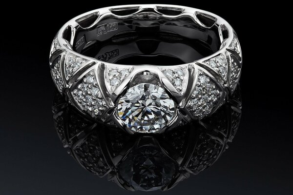 White gold ring with diamonds on glass