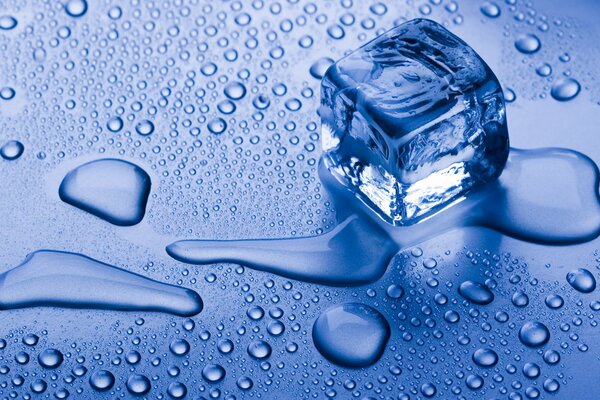 An ice cube on a blue surface