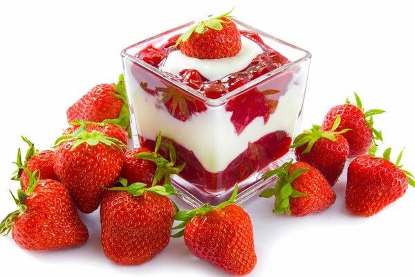 Dessert strawberries with cream in a clear glass