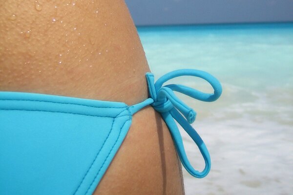 A girl in a blue swimsuit on the sea