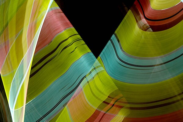 Abstract of an imaginary fabric in three colors green, red and blue on a black background