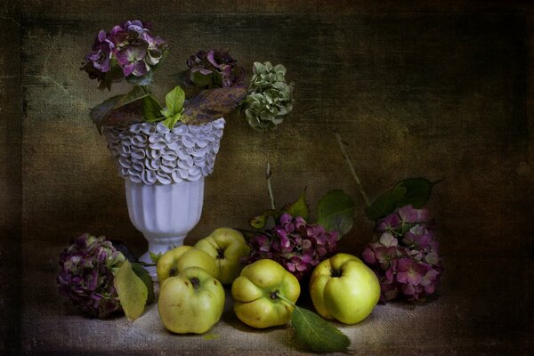 Retro still life with a vase of flowers and apples