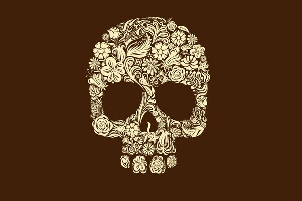 El fondo oscuro muestra un cráneo de flores