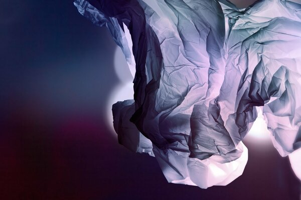 Made of crumpled crumpled cellophane of gray color on a dark background