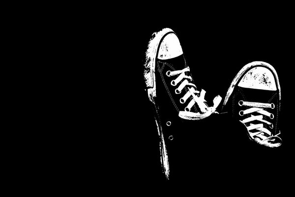 Black sneakers on a black background