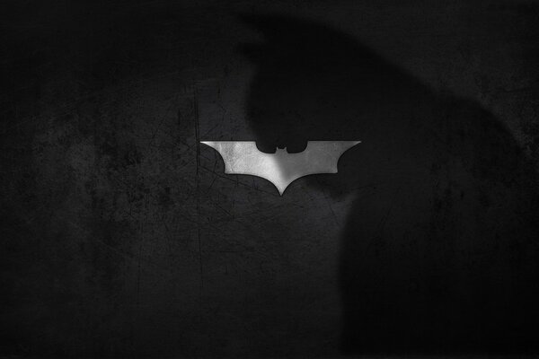 Batman-Schatten-Logo auf Fledermaus-Hintergrund