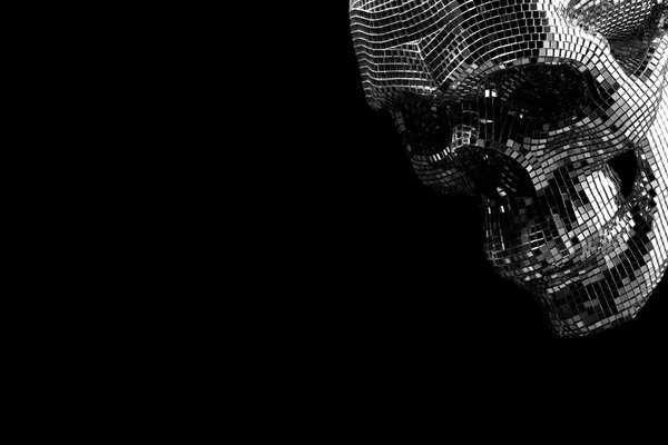 A skull made of mirror elements on a dark background