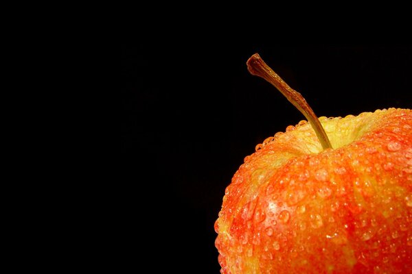 Apple with drops on a black background