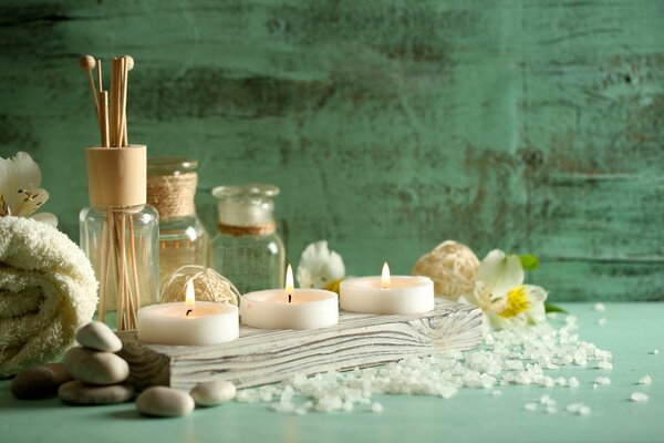 Preparation for a spa procedure with towels and candles