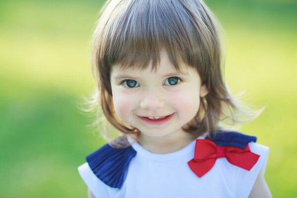 A little girl in nature smiles