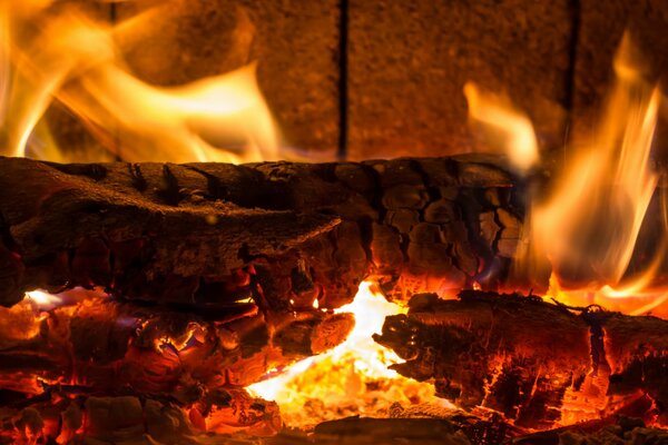 Wood burning in the fireplace. Red, hot flame